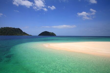 Beautiful Andaman crystal sea at shore on Khai island against blue sky in Satun province, Thailandの写真素材