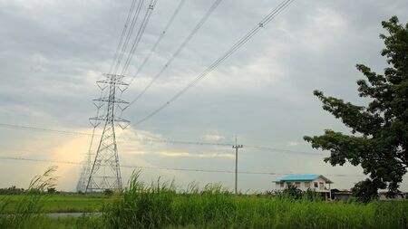 High voltage post or tower with ray light through the cloudの写真素材
