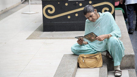 BANGKOK-MAR 16  Unidentified old Sikh woman sitting on stairs near Phahurat Road on March 16, 2013...
