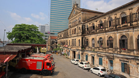 BANGKOK-MAR 16  Antique Bangrak fire station with red fire trucks against blue sky on March 16, 2013 in Bangkok, Thailand  Bangrak fire station, founded in 1890, is still in operation until now  のeditorial素材