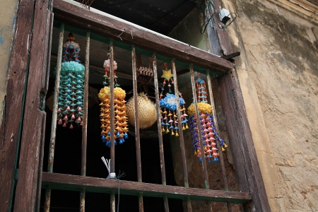 Colorful mobile hangers hanging at wooden windowの写真素材