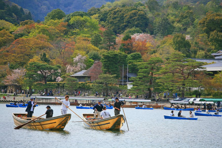 ARASHIYAMA-APR 17  Unidentified people enjoy cherry blossom party, called Hanami, by floating on boats on April 17, 2011 in Arashiyama, Japan  Here, Kyoto outskirt, is famous on sakura blossom time  のeditorial素材
