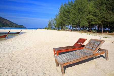 Wooden chairs on the beach for relax at Koh Lipe in Satun, Thailandの写真素材