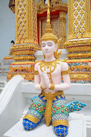 carving salute God statue with art pattern on a wall の写真素材