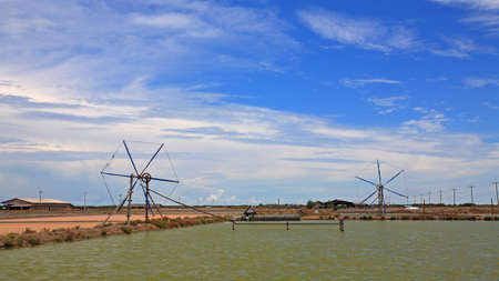  windmill near the pond against blue sky, Thailandの写真素材