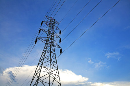 high voltage tower against blue sky