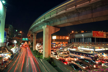 BANGKOK-APR 19  Elevated sky train railway above Phaholyothin road with light trails on April 19, 2013 in Bangkok, Thailand  Each skytrain can carry over 1,000 passengers through 32 stations    のeditorial素材