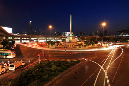 BANGKOK-APR 19  Military victory monument with light trail on street at twilight on April 19, 2013 in Bangkok, Thailand  Monument, built in 1941, demonstrates a victory sign of war with France   のeditorial素材