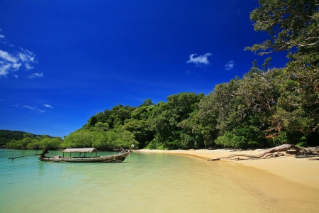 Mai Ngam beach with wooden boat and blue sky at Koh Surin, Thailand の写真素材