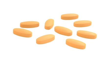 Yellow pills  set isolated on white backgroundの写真素材