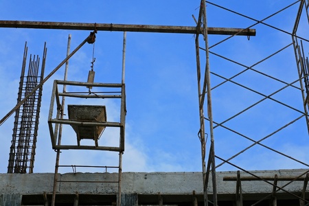 Building construction  old metal wheelbarrow cart on metal scaffoldの写真素材