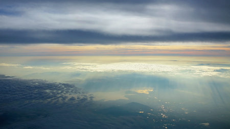 sun s rays through the clouds reflecting to the river