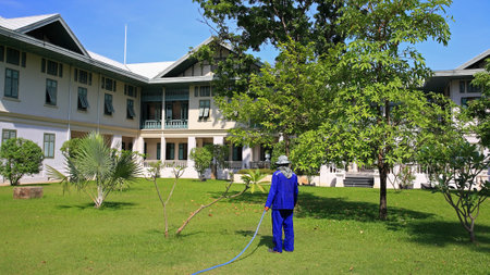 Gardener spraying water into the gardenのeditorial素材