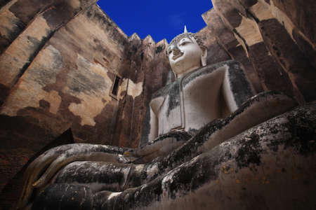 Large ancient buddha statue against blue sky at wat Srichum. Sukhothai Province - Thailandの写真素材