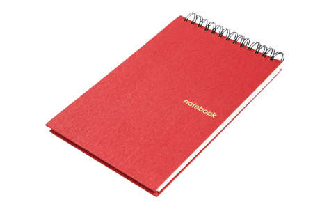 Red notebook with spiral bound isolated on whiteの写真素材