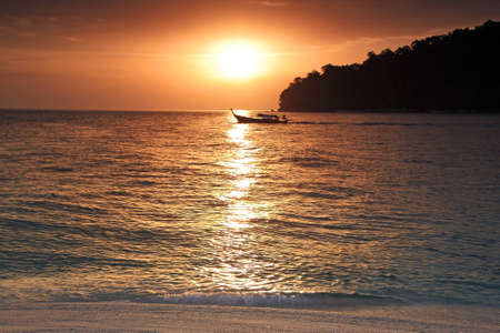 Boat sailing on sea at sunset, Thailandの写真素材