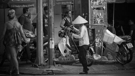 HANOI - JULY 20: Unidentified Vietnamese woman carries durians to sell on July 20, 2012 in Hanoi, Vietnam. Hanoi has an estimated population of 6.5 million making it the second largest City in Vietnam.のeditorial素材