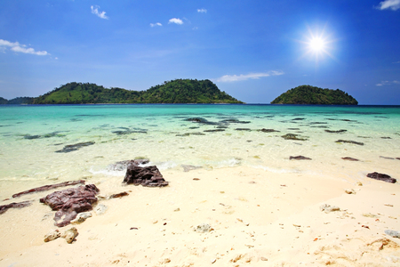 Beautiful beach and crystal sea against sunbeam and blue sky in Thailandの写真素材