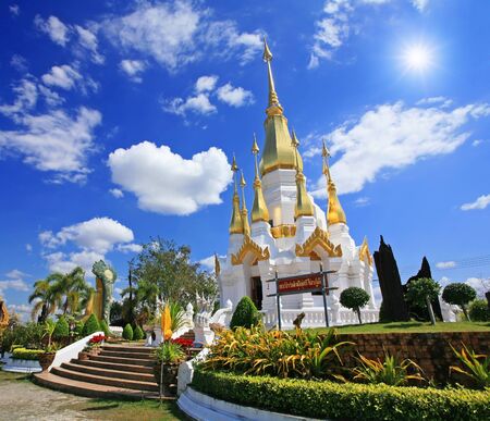 Thai Pagoda against sunbeam and blue sky at wat Tham Kuha Sawan in Ubon Ratchathani Province,Thailandの写真素材