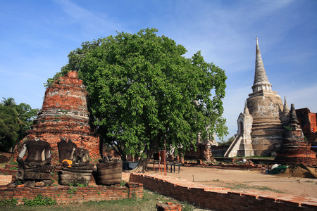 Ruined Buddha statues near small pagoda at Wat Phra Sri Sanphet in Ayutthaya, Thailandの写真素材
