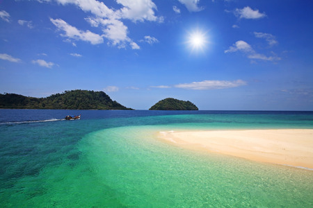 Turquoise and crystal Andaman sea and white sand against sunbeam and blue sky at Lipe island, Thailandの写真素材
