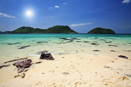 Beautiful beach and crystal sea against sunbeam and blue sky in Thailandの写真素材