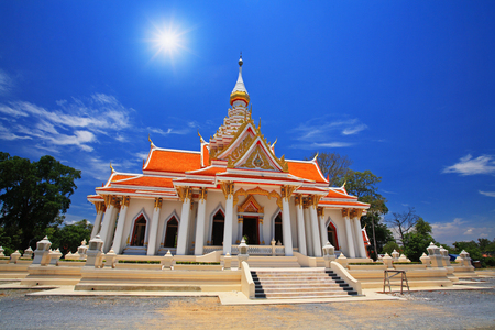 Thai temple against sunbeam and blue sky at wat Thammasala in Nakhon Pathom, Thailandの写真素材