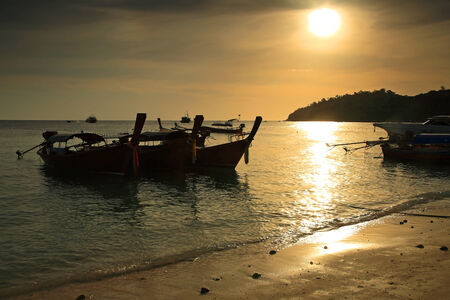 long tail boats at sunset at Koh Lipe in Satun, Thailandの写真素材
