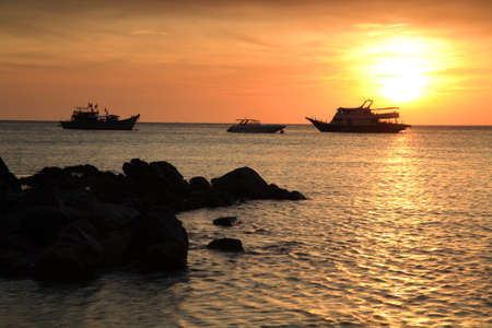 sunset above the sea and cruise ships at Koh Lipe, Thailandの写真素材