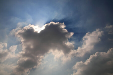 Dramatic sun beams passing through cloudsの写真素材