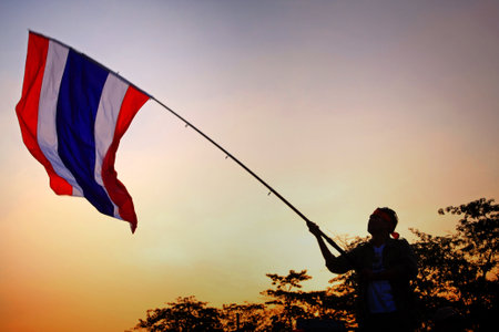 BANGKOK-JAN 13: Unidentified protestor raises Thai flag at Ladprao junction to anti government and ask to reform before election with 'Shutdown Bangkok concept' on Jan 13, 2014 in Bangkok, Thailand.のeditorial素材