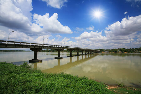 Bridge across the river against blue sky and sunbeamの写真素材