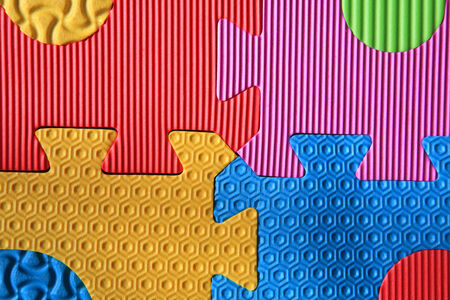 Colorful jigsaw foam texture for children playの写真素材