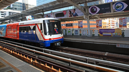 BANGKOK, THAILAND-MARCH 27, 2014: BTS Sky train arrives to Phloen Chit station. Elevated rails cover...