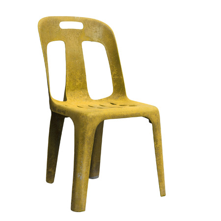 Old yellow plastic chair isolated on white backgroundの写真素材