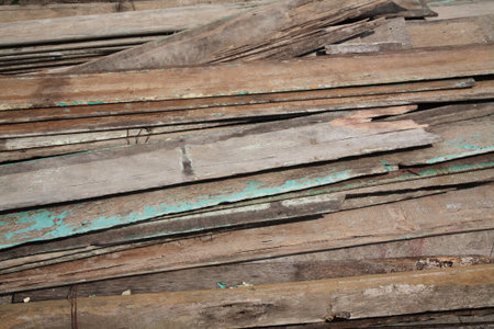 Stack of old and dirty lumber at construction site