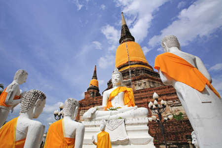 Buddha statues against ancient pagoda at Wat Yai Chaimongkol temple in Ayutthaya, Thailandの写真素材