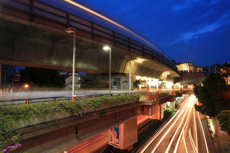 BANGKOK, THAILAND - JULY 07, 2012: Light trails on elevated rail at Victory monument station with twilight sky. Elevated rails cover business, resident, and tourist areas by 32 stationsのeditorial素材