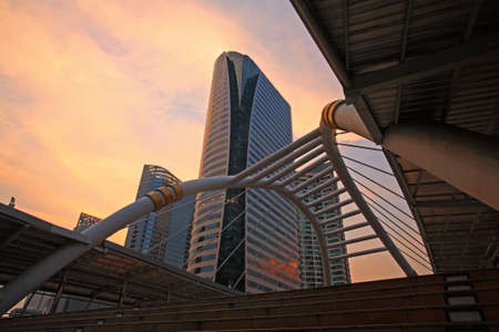 Bangkok skywalk above Sathorn-Narathiwat junction at dusk with twilight sky, Thailandの写真素材