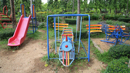 Train and slider toys at old children playground in the parkの写真素材