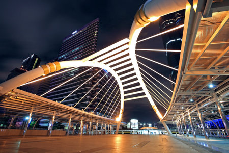 BANGKOK, THAILAND -JULY 07, 2012: Sky walk architecture at twilight for passengers to transit between Sky Transit and Bus Rapid Transit Systems at Sathorn-Narathiwas junction.のeditorial素材
