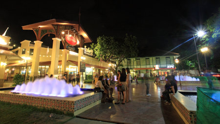 BANGKOK-JULY 07, 2012: Unidentified people at Asiatique The Riverfront with fountain. Three are more than 500 outdoor shopping stores in Asiatique The Riverfront.のeditorial素材