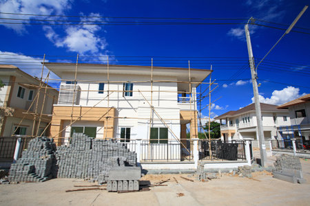 Modern house under construction against blue skyのeditorial素材