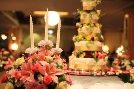 Candles and flower bouquets decorated near wedding cakeのeditorial素材