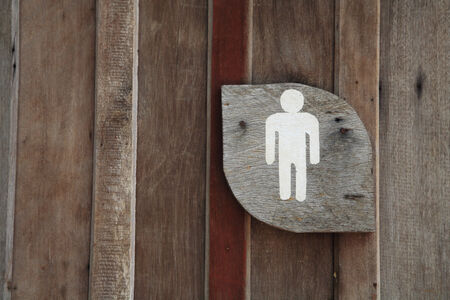 Wooden Men Toilet or restroom Sign at the wallの写真素材