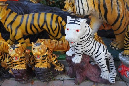 White and yellow tigers' statue decorated in the gardenの写真素材