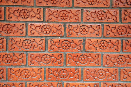 Brick wall with floral carved pattern, Textured backgroundの写真素材