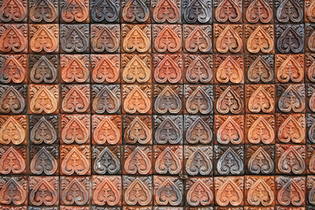Brick wall with floral leaf carved pattern