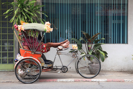KORAT, THAILAND - MARCH 14, 2015: Unidentified rider sleeping on tricycle. Tricycle called Sam Lor  in Thai language is very useful to transit in small street in Thailandのeditorial素材