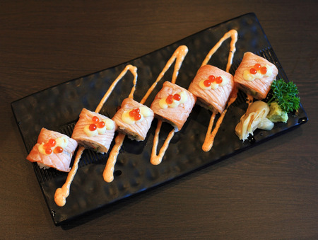 Salmon sushi rolls with spicy sauce on the plateの写真素材